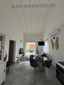 a living room with a table and chairs at Serene Shores, Punta Azul, Westpunt in Westpunt +12 photos