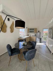 a living room with a table and chairs and a kitchen at Serene Shores, Punta Azul, Westpunt in Westpunt