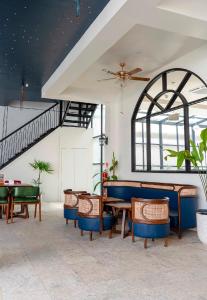 a dining room with tables and chairs and a ceiling at du PALAIS Hotel in Sultan Thaha Airport