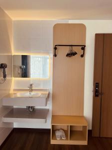 a bathroom with a sink and a mirror at The Cloud Hotel Bình Dương in Ga Phú Trung +21 photos