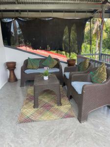a patio with couches and a table with at CJ cozy tiny home in Santa Barbara