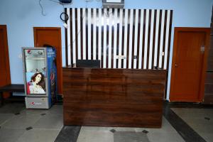 a wooden cabinet with a video game machine in a room at Hotel Ram Way in Visakhapatnam