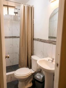 a bathroom with a toilet and a sink at La Terraza in Oxapampa