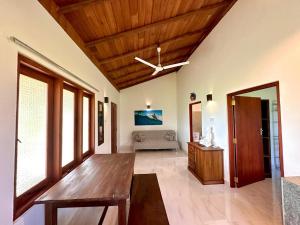 a living room with a wooden table and a couch at Body,Mind & Soul in Bentota +18 photos