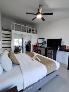 a bedroom with a large bed with a ceiling fan at the beachhouse cebu in Dalaguete +53 photos