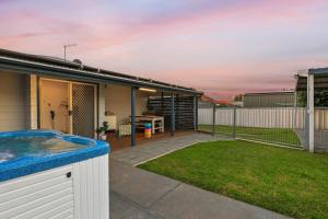 a house with a hot tub in the yard at Sunday Valley in Cessnock