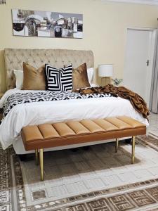 a bedroom with a large bed with pillows on it at Cozy Corner Monavale in Harare