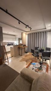 a living room with a couch and a piano at Cozy house with pool in Campo Grande