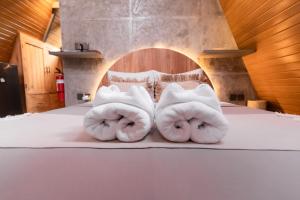 two towels are sitting on top of a bed at Delta Casa Ubud - A-Frame Jungle Retreat with Volcano View and Hot-Tubs in Gianyar +287 photos