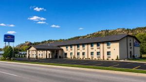 a large building on the side of a road at Baymont by Wyndham Hot Springs in Hot Springs