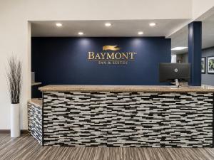 a lobby with a blue wall with a sign on it at Baymont by Wyndham Hot Springs in Hot Springs