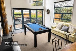 a pool table in a living room with a couch at Spacious Mt Hutt Ski & Summer Lodge in Methven with Spa in Methven