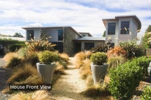 a house front view of a house with potted plants at Spacious Mt Hutt Ski & Summer Lodge in Methven with Spa in Methven