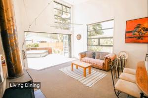 a living room with a couch and a table at Spacious Mt Hutt Ski & Summer Lodge in Methven with Spa in Methven