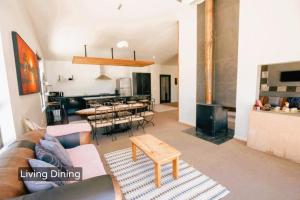 a living room with a couch and a table at Spacious Mt Hutt Ski & Summer Lodge in Methven with Spa in Methven