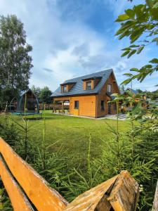 a house with a playground in a yard at Chillout House Serwy in Serwy