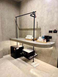 a shelf in a bathroom with towels on it at Angela Stay in Pattaya