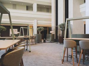 a row of tables and chairs in a lobby at Meliá Sitges in Sitges +75 photos