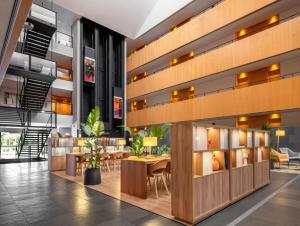 a lobby of a building with a table and chairs at INNSiDE by Meliá Barcelona Aeropuerto in El Prat de Llobregat +44 photos