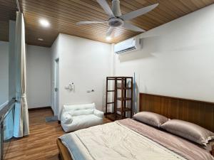 a bedroom with a bed and a ceiling fan at Naruemon in Ban Madua Wan