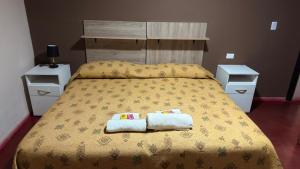 a bedroom with a bed with two towels on it at Cielo andino in Antofagasta de la Sierra +7 photos