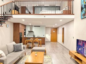 a living room with a couch and a table at PentStudio Westlake - Cozy Duplex - New Apartment in Hanoi