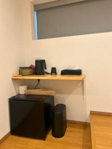 a shelf on a wall with a computer on it at Leisure Hotel II 東中野 in Tokyo