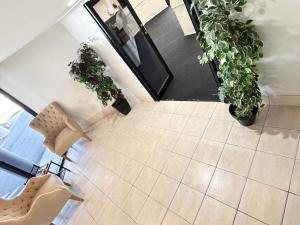 an overhead view of a living room with plants at Centrepoint Motor Inn in Rockhampton