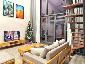 a living room with a christmas tree and a couch at PentStudio Westlake - Cozy Duplex - New Apartment in Hanoi