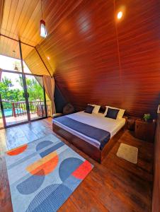 a bedroom with a bed in a wooden room at Green Breeze Villa in Katugastota +52 photos