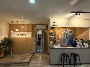 a restaurant with a counter and two stools at Zero Gravity Homestay 零重力民宿 in Semporna