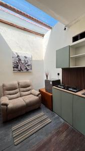 a living room with a couch and a kitchen at Sutji living in Sanur