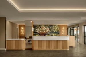 a lobby of a hotel with a painting on the wall at Courtyard by Marriott Darwin in Darwin +36 photos