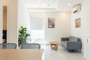a living room with a couch and chairs and a table at La Living Collection in Ho Chi Minh City