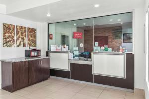 a store front with a counter with a microwave at Red Roof Inn Houston - Jersey Village in Houston
