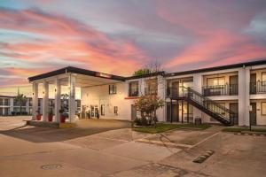 a building with a staircase in a parking lot at Red Roof Inn Houston - Jersey Village in Houston
