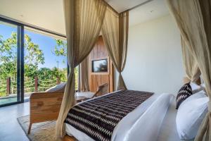 a bedroom with a bed and a large window at Villa Karilla in Toyapakeh +86 photos
