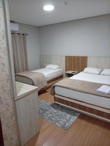 a bedroom with two beds and avisor at Terraza Frontera Hotel in Pedro Juan Caballero