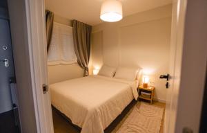 a small bedroom with a white bed and two lamps at Alma de Mar in Finestrat +26 photos