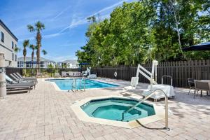 a swimming pool with a hot tub in a yard at Courtyard by Marriott St. Augustine I-95 in St. Augustine