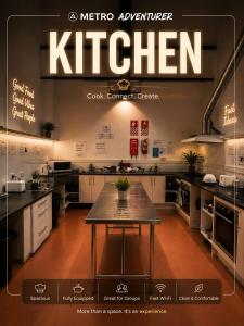a kitchen with a table in the middle of it at Metro Adventurer Backpackers in Auckland