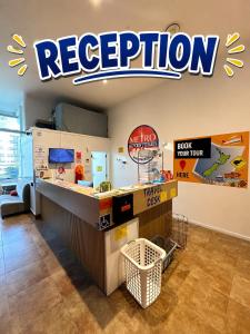 a restaurant with a reception counter with a restaurant sign at Metro Adventurer Backpackers in Auckland