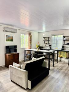 a living room with a couch and a table at Villas Cozy Sloth in Puerto Viejo