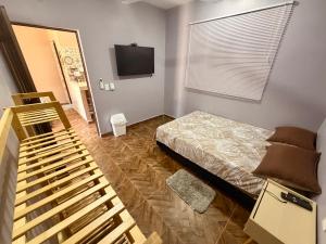 a bedroom with a bed and a flat screen tv at Casa Zapata in Chano