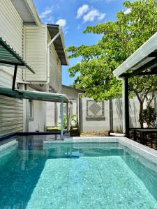 a swimming pool in the backyard of a house at Villas Cozy Sloth in Puerto Viejo