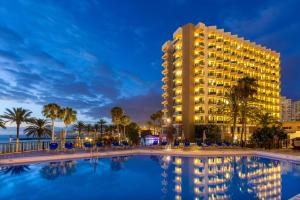 a hotel with a pool in front of a resort at SOL by Meliá Tenerife in Playa de las Americas