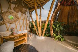 a room with a tub and a balcony with plants at Bamboo amazing villa sidemen in Selat +34 photos