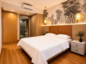 a bedroom with a large white bed and a bathroom at Axis Residences Apartment in Phnom Penh +39 photos