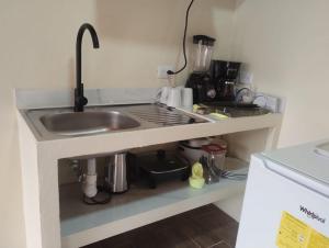 a kitchen with a sink and a counter top at Refugio de Paz Providencia in El Copey