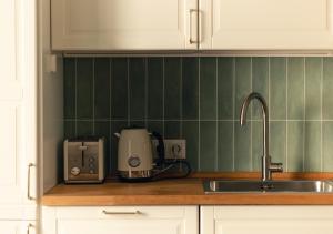 a kitchen counter with a sink and a toaster at Alma de Mar in Finestrat